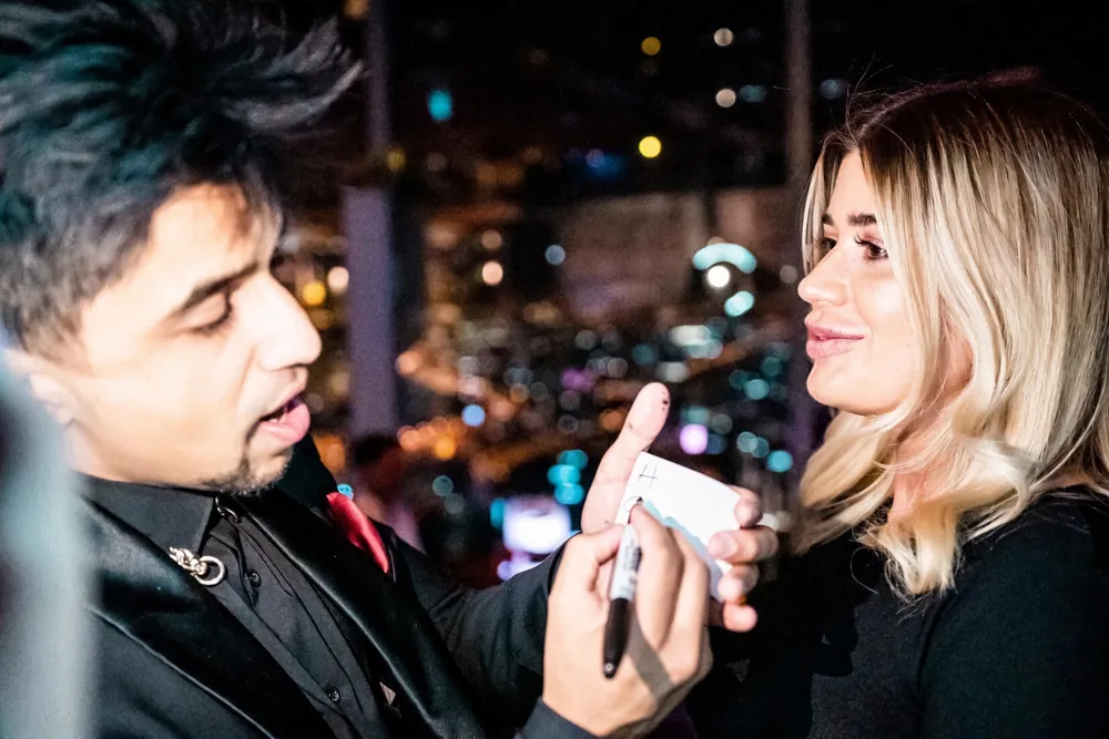 Nabeel performs close-up magic for a guest.