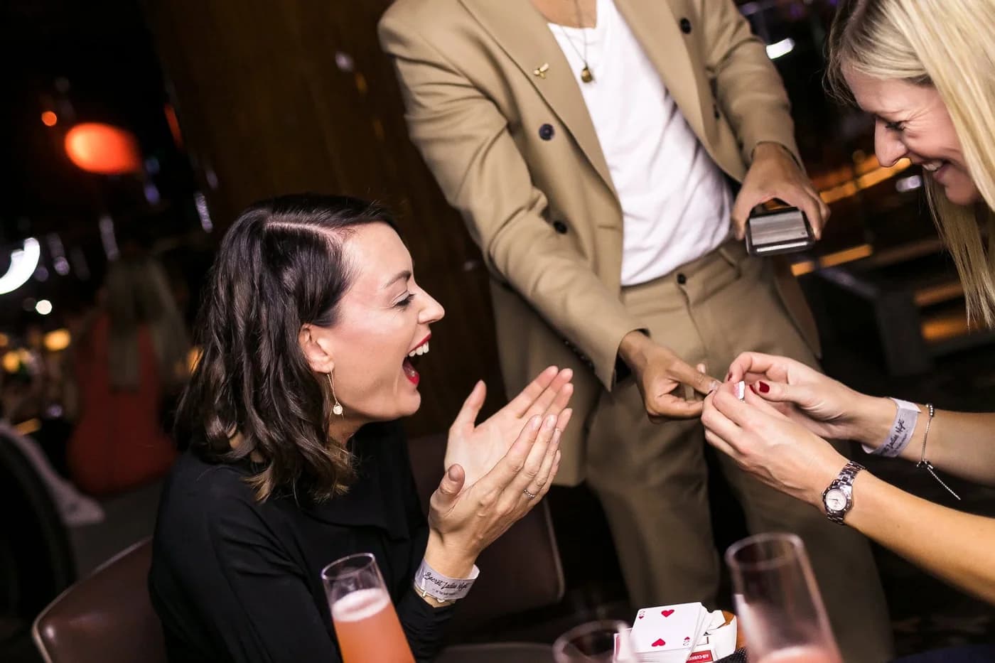 Two guests laugh and react during a close-up performance.
