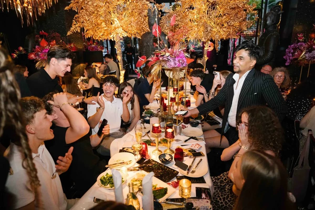 Nabeel performs for guests around a birthday dinner table in Frankfurt.