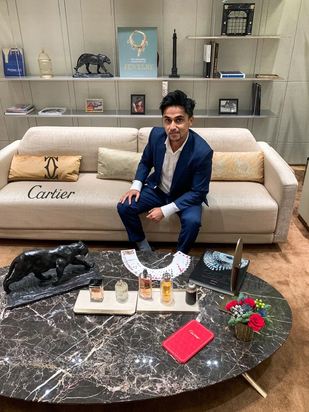 Nabeel seated in a lounge with cards on the table.