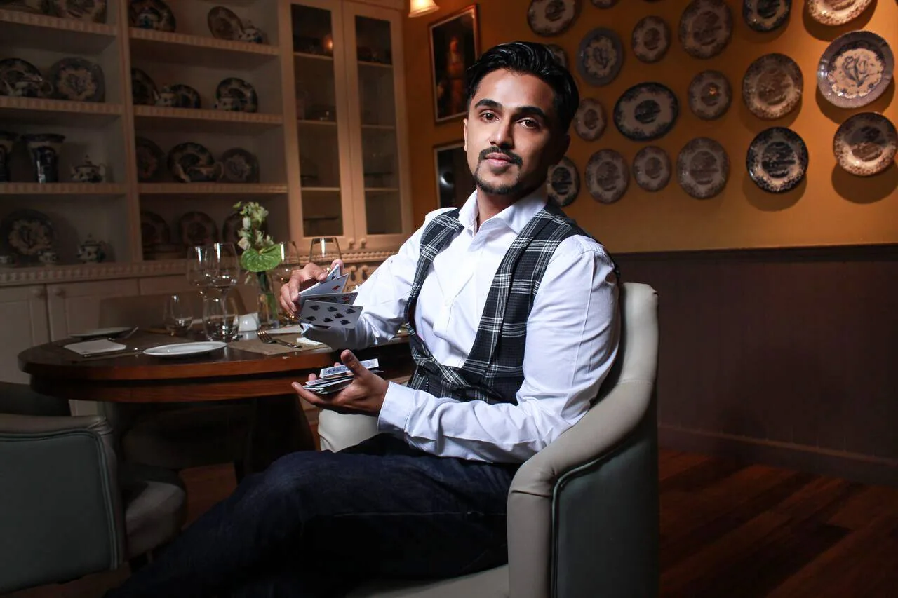 Nabeel seated with a cigar in a lounge.