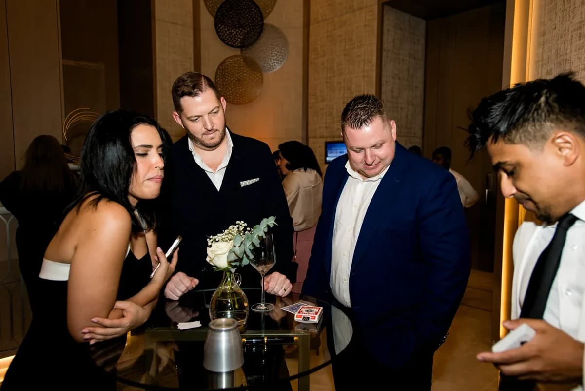 Nabeel shares close-up magic with guests at a gathering.