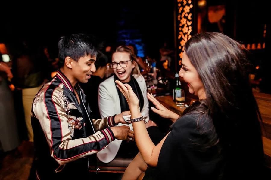 Guests share a laugh during a private-party magic performance.