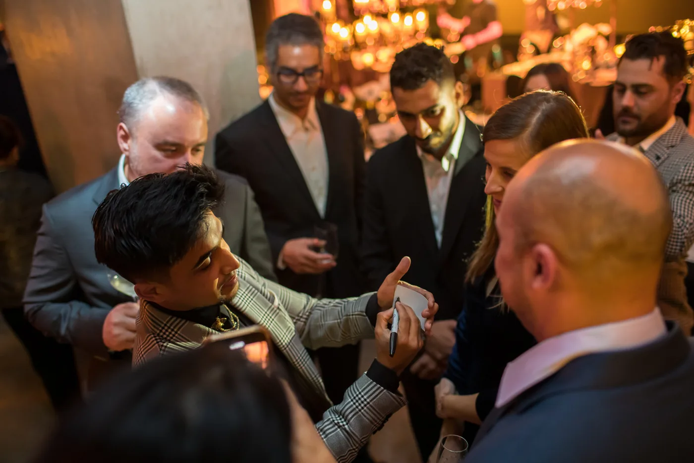 Guests gather around Nabeel for a close-up performance.